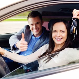 Happy driving student with a car keys Happy driving student with a car keys